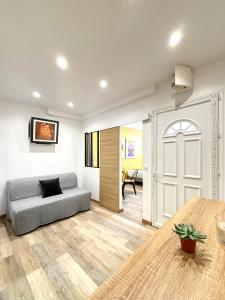 a living room with a couch and a door at Villa Des Bégonias - PSG in Le Pré-Saint-Gervais