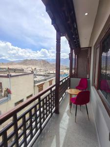 a room with a table and a chair on a balcony at The Clove Ladakh in Leh