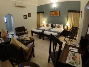 a hotel room with two beds and a table at Thar Oasis Resort and Camp in Dechu +34 photos