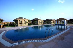 a swimming pool in front of a villa at Thar Oasis Resort and Camp in Dechu