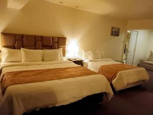 A bed or beds in a room at Hotel Paradis Suite Cusco