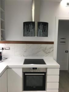 a kitchen with white counters and a stove top oven at Casa Regina in Civitanova Marche +7 photos
