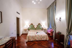 a hotel room with a bed and a table and chairs at Hotel Fortuna in Perugia