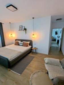 a bedroom with a large bed and a living room at Sibiu City Lights in Şura Mare