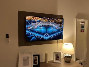 a flat screen tv hanging on a wall at La casa di Rebecca in Salerno +22 photos