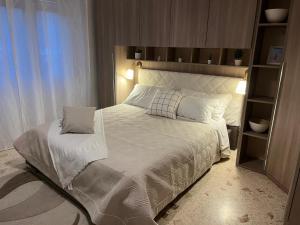 a bedroom with a large bed with white sheets and pillows at La casa di Rebecca in Salerno
