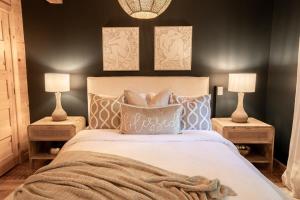 a bedroom with a large bed with two lamps at Chalet Chic Rustique & SPA - Tremblant in Lac-Superieur