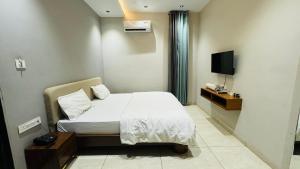 a hotel room with a bed and a television at Hari Leela fort view palace in Chittaurgarh +33 photos