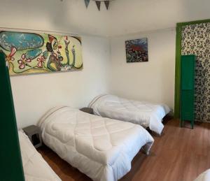 Postel nebo postele na pokoji v ubytování Art Hostel Casa Chaman