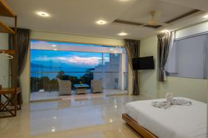a bedroom with a bed and a view of the ocean at Sunset Lagoon Villa Rihanna in Bangrak Beach +74 photos