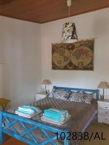 a bedroom with a bed with two pillows on it at Casa Mega Fundeira, natureza e praia fluvial in Pedrógão Grande