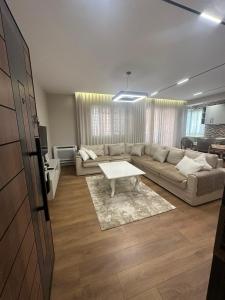 a living room with a couch and a coffee table at Renev Apartments Tirana in Tirana