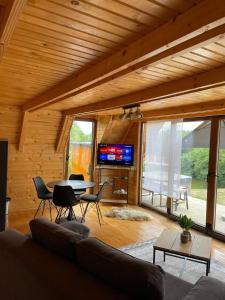 a living room with a couch and a table at Chalet Licina - Bjelašnica in Klanac