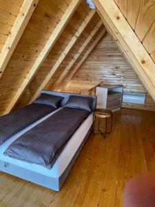 a bedroom with a bed in a attic at Chalet Licina - Bjelašnica in Klanac