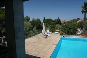 a view of a swimming pool from a house at Presqu`ile de Giens in Hyères