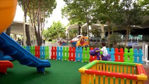 a childrens play area with a colorful playground at Inheritor Resort in Lezhë