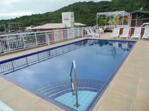 a large swimming pool on top of a building at Hotel Maricá in Penha