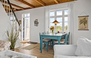 a living room with a blue table and chairs at Two-Bedroom Holiday Home In Ringkobing in Ringkøbing
