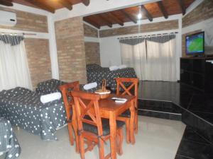 a living room with a table and chairs at El Viejo Molino in Chilecito