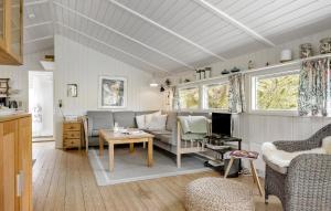 a living room with a couch and a table at Tziki in Fanø