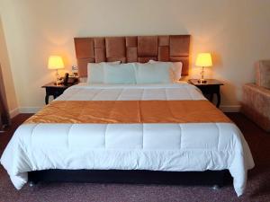 A bed or beds in a room at Hotel Paradis Suite Cusco
