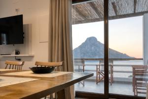a dining room with a view of the ocean at Villa Katerina - Between sea & mountain in Kalymnos