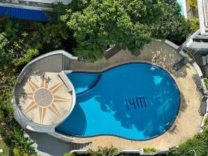an overhead view of a large swimming pool with aiki at Patong Tower 2 Bedrooms Sea View Top Top in Patong Beach