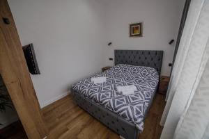 a small bedroom with a bed in a room at AcAsA in Turda +3 photos