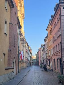 a cobblestone street in a city with tall buildings at Old Town Residence, Historic Centre Castle Square in Warsaw