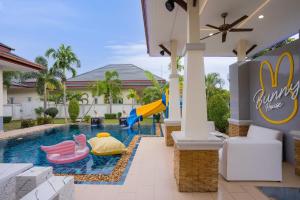 a pool at a resort with a slide at Bunny House Pool Villa Na Jomtien in Na Jomtien