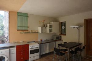 a kitchen with a sink and a table with chairs at Presqu`ile de Giens in Hyères