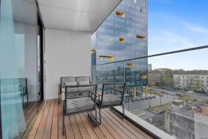 a balcony with two chairs and a large window at LAX Exquisite 1BR,1BATH -City Skyline Views in Bucharest