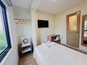a bedroom with a white bed and a window at Zentra Hotel in Chiclayo