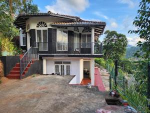 a house under construction with a balcony on top at Suntech Holiday Home Bandarawela in Bandarawela