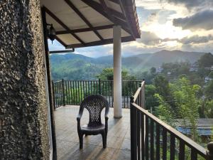 a chair sitting on a balcony with a view at Suntech Holiday Home Bandarawela in Bandarawela +8 photos