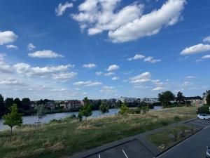 a view of a river from a parking lot at Le Compiègnois in Compiègne