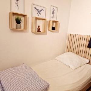 a bedroom with a bed and some pictures on the wall at La Parenthèse in Pornic +18 photos