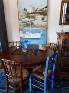 a dining room table with chairs and a table with a boat at Semi's House in Batsi +43 photos