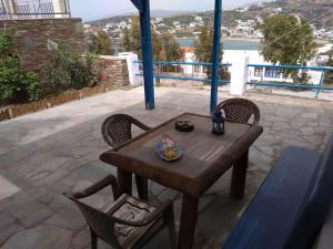 a wooden table and two chairs on a patio at Semi's House in Batsi