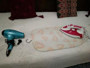 a pair of shoes and a blow dryer on a bed at Semi's House in Batsi