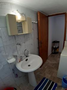 a bathroom with a white sink and a mirror at Glyfada's Family Apartment in Glyfada Fokidas +41 photos