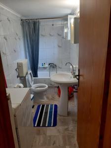 a bathroom with a toilet and a sink at Glyfada's Family Apartment in Glyfada Fokidas