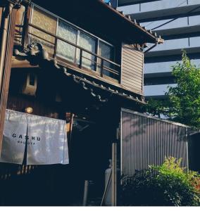 a cat sitting on a balcony of a building at Machiya Villa Gashu - Vacation STAY 17142 in Nagoya