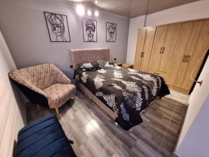 a bedroom with a bed and a chair at Vélez Loft in Vélez