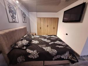 a bedroom with a bed and a flat screen tv at Vélez Loft in Vélez +18 photos