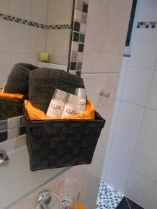 a basket of toiletries in a bathroom with a shower at Apart Zangerle in Kappl