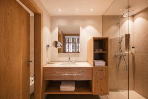 a bathroom with a sink and a shower at Boutique Hotel Pachers in Bressanone