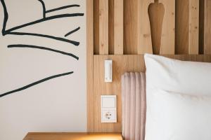 a bedroom with a bed with a white pillow at Boutique Hotel Pachers in Bressanone