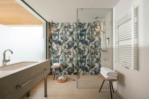 a bathroom with a shower with a shower curtain at Boutique Hotel Pachers in Bressanone