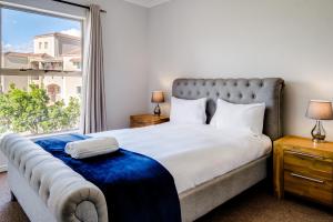 a bedroom with a bed and a large window at Belina - Bougain Villas Estate View in Cape Town +43 photos